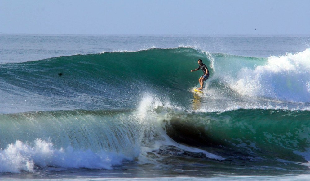 Surfer on a Pacific wave